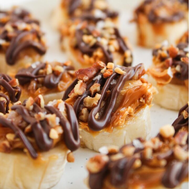 Banana snickers bite on a plate surrounded by more.