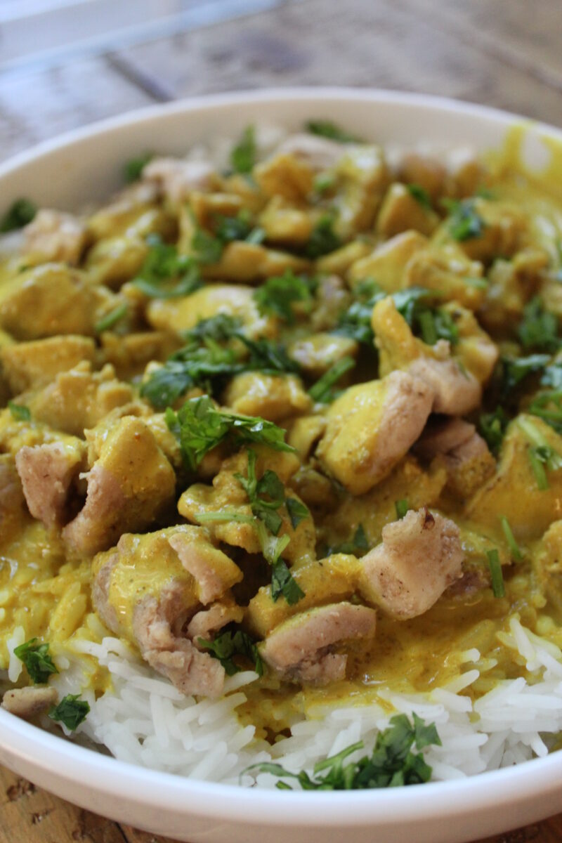 curry sauce on chicken and rice, topped with cilantro