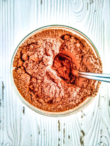 Dairy free hot cocoa mix in mason jar with spoon.