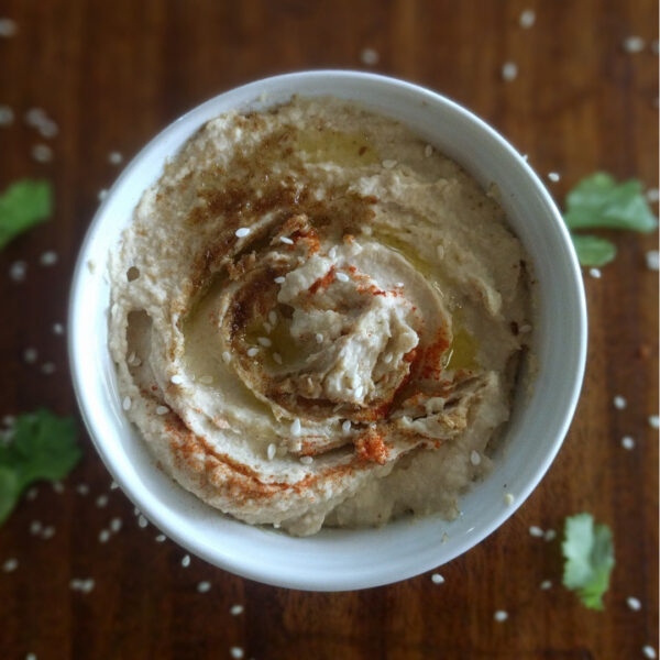 creamy garlic hummus in white ramekin