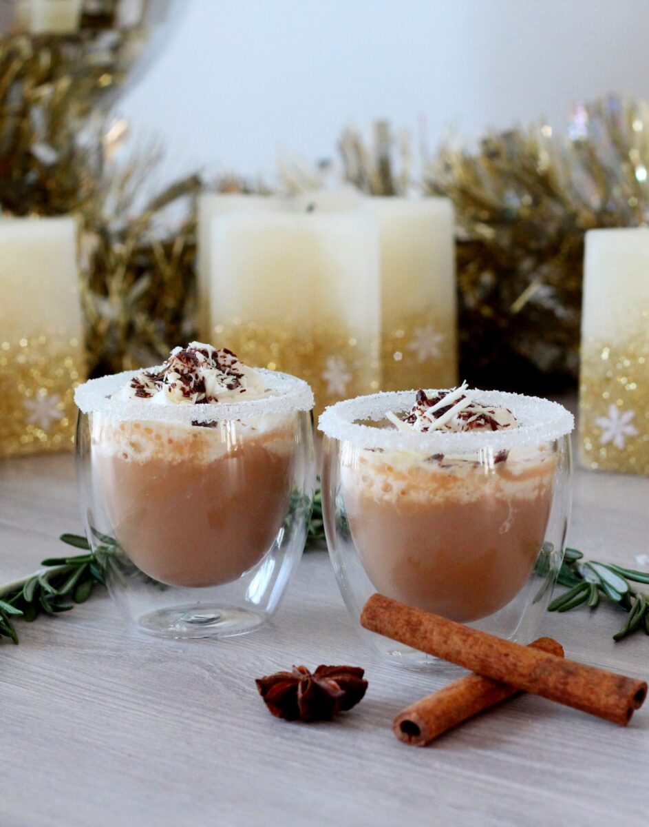 chocolate coffee drinks with a scream and shaved chocolate in small glasses rimmed with white sugar, with festive Christmas decorations