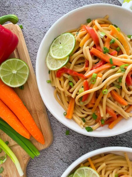 Thai noodles in a bowl with veggies on the side