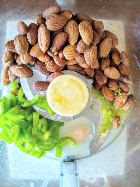 All ingredients in food processor for almond dip with jalepeno and lime