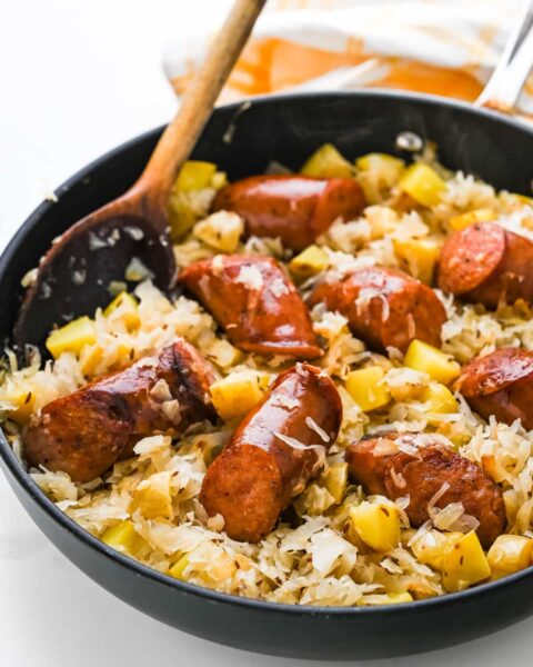 cooked slices of smoked sausages with Onions, Garlic, Sauerkraut, Yukon Gold Pot in a pot