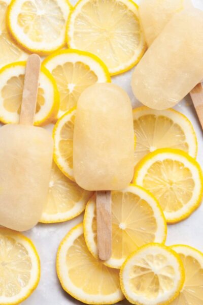 lemondae popsicles on top of lemon slices and ice cubes