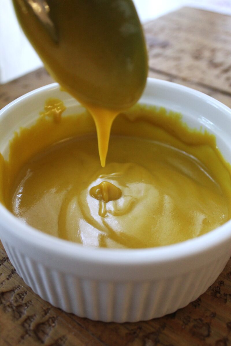 honey mustard dressing in white ramekin all mixed