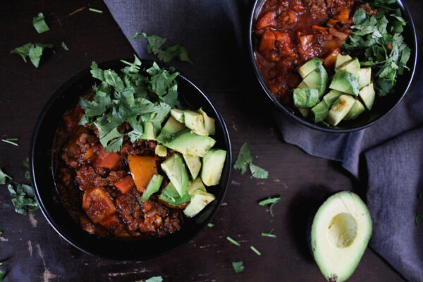 bean and bacon paleo chili in black bowls on table
