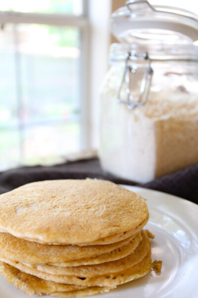 stack of pancakes with jar in background