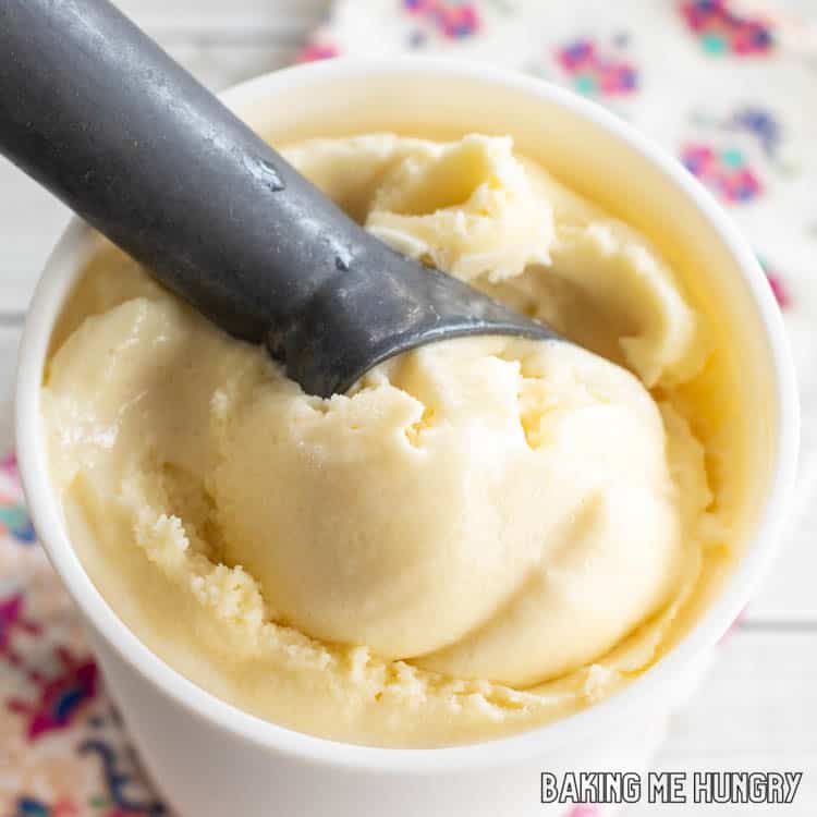white ice cream with scooper in a white mug