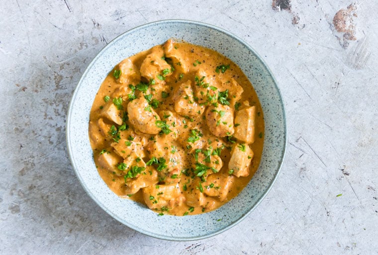 Instant Pot Peanut Butter Chicken in bowl on Gray counter from Recipes from a Pantry