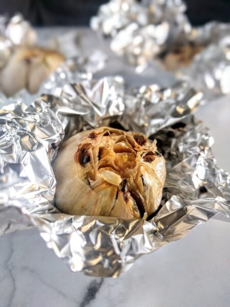 oven roasted garlic in foil fresh out of the oven.