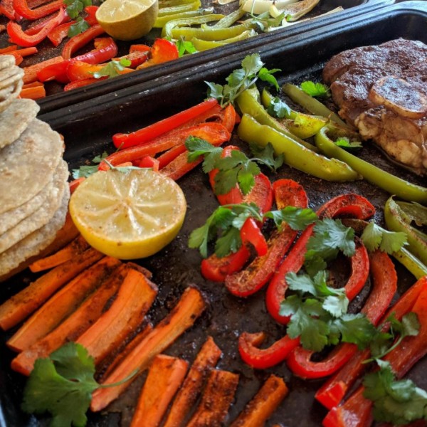 Meat and veggies on a cooking sheet