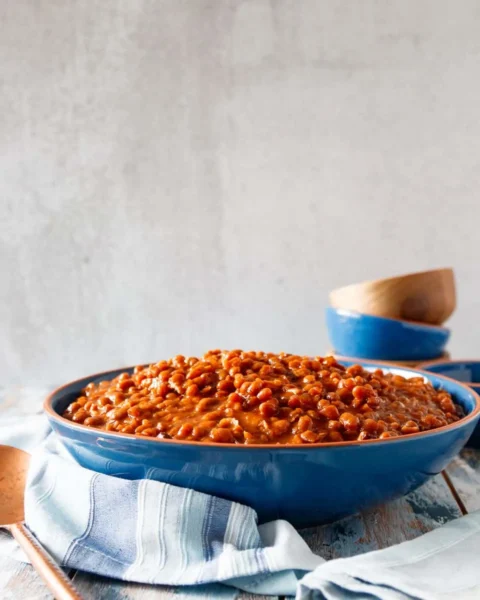 slow cooker baked beans in a blue bowl