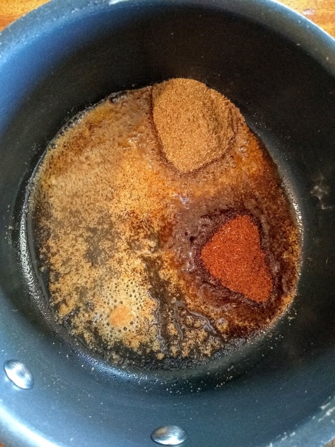 oil and spices in sauce pan
