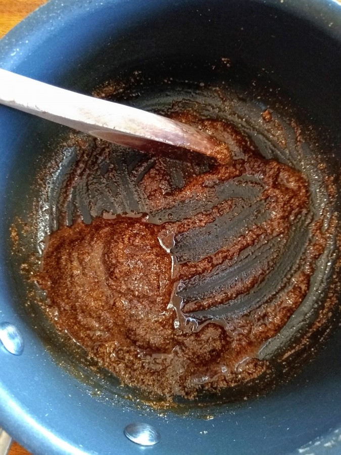 oil and spices mixed in pan