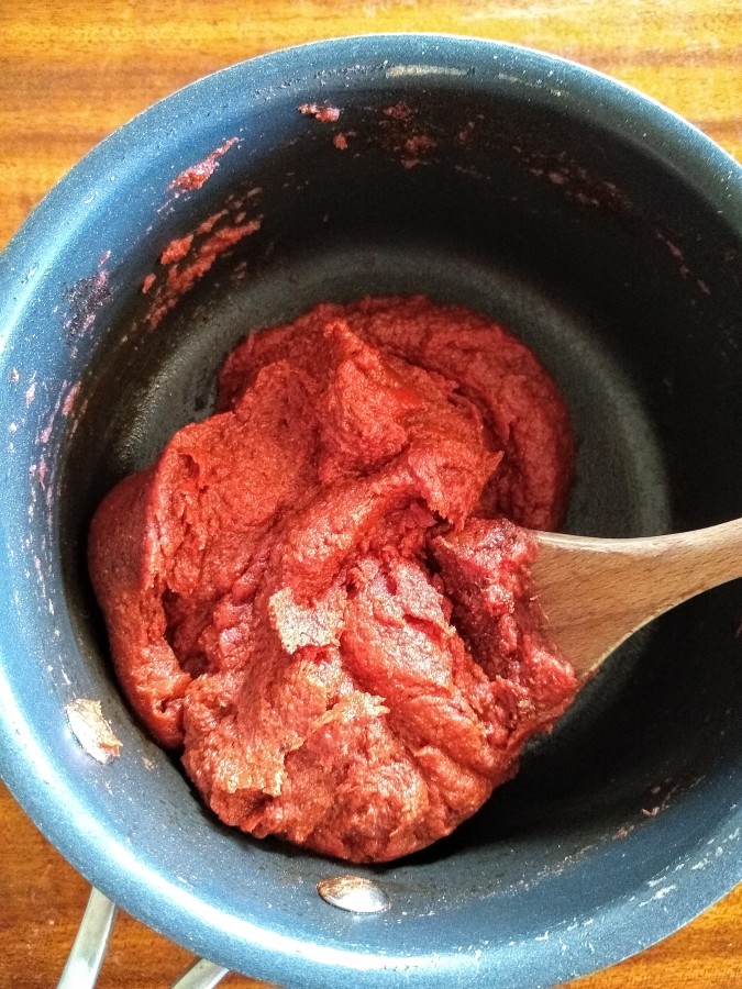 Stir the tomato paste around with the spices.