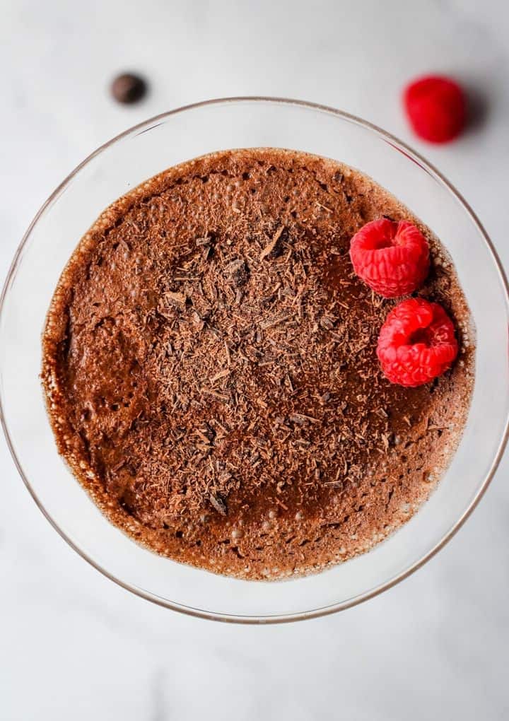 overhead shot of chocolate mouse topped with raspberries and chocolate shavings