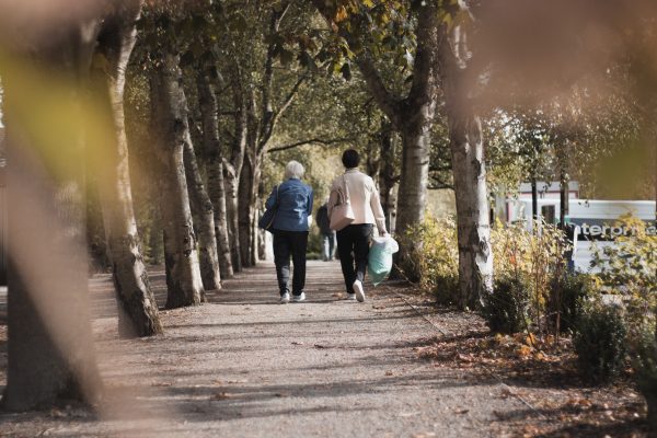 two people walking on path